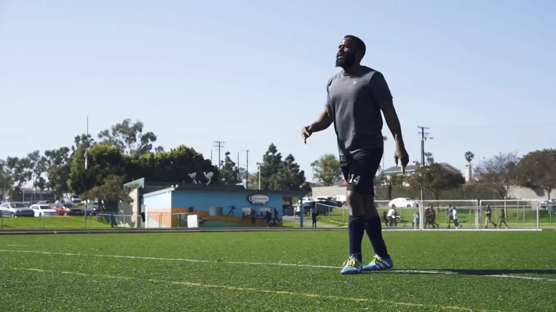 Football players warming up on a pitch.
